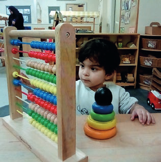 A child playing with an abacus