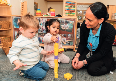 A key worker playing with two toddlers